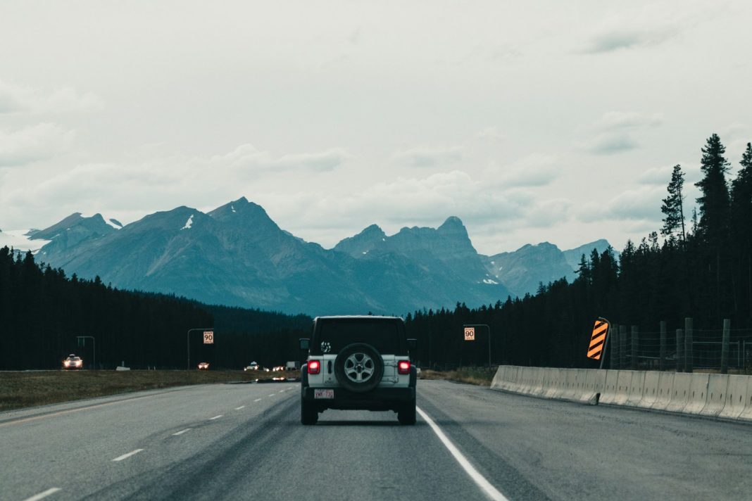 black suv on road near mountain during daytime